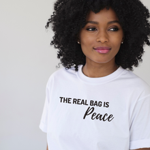Load image into Gallery viewer, White tshirt with the words the real bag is peace